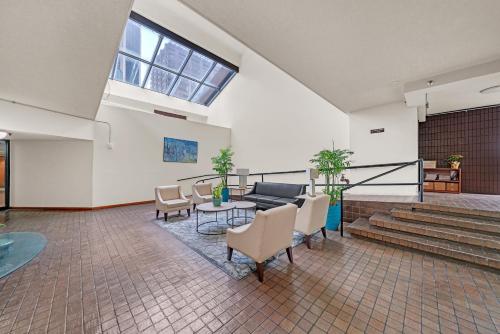 a living room with a couch and a table and chairs at Chic DT Honolulu Executive Condo condo in Honolulu