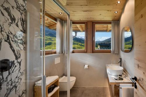 a bathroom with a shower and a toilet and a sink at Chalet La Varieté in La Villa