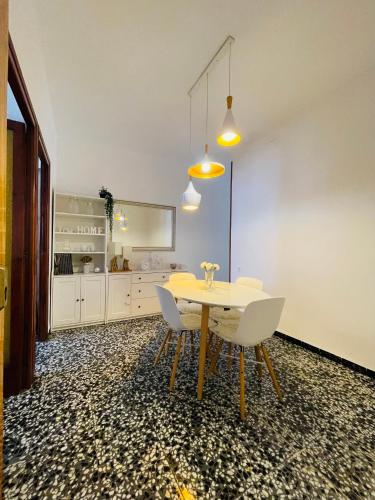 a dining room with a table and two chairs at Charment appartement a vinaros in Vinarós
