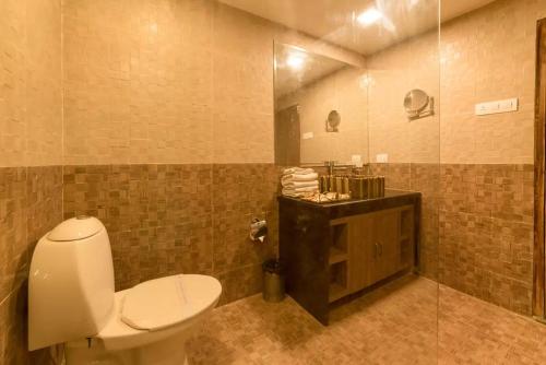 a bathroom with a white toilet and a shower at Chokhi Dhani Desert Camp in Sām