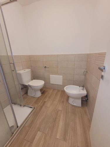 a bathroom with two toilets and a sink at HOUSE AIRPORT Catania 2 in CTA