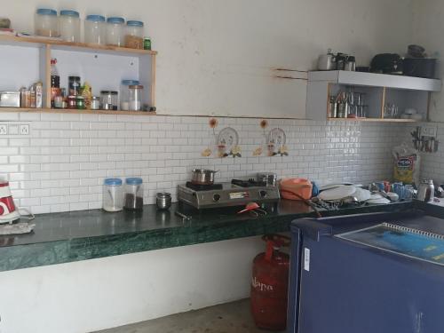 a kitchen with a counter top with a stove at Entire apartment khajuraho in Khajurāho