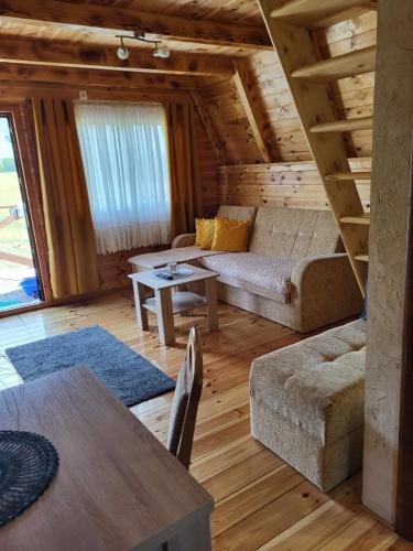 a living room with a couch and a table at Cottage Forest Hill in Žabljak