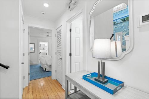 a living room with a table and a lamp at Just for Fun 2 in Santa Rosa Beach