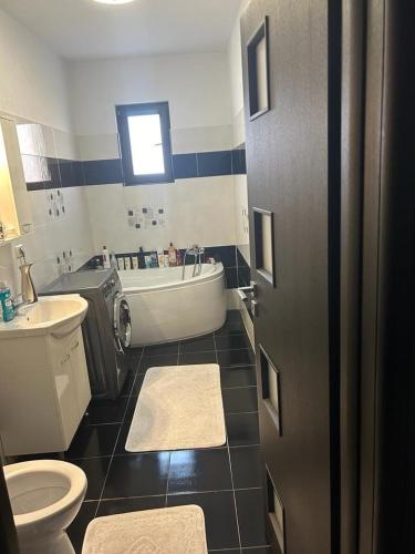 a bathroom with a tub and a toilet and a sink at Lux studio 46 meters in Colentina