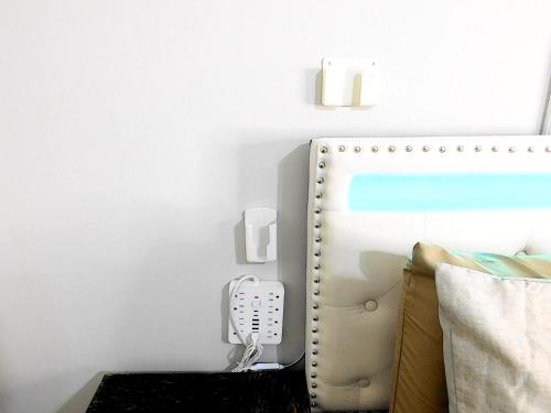 a phone hanging on a wall next to a bed at The Blue Victorian Waterview Home in Hampton