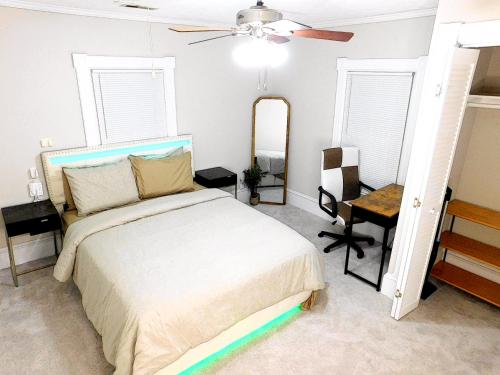 a bedroom with a bed and a ceiling fan at The Blue Victorian Waterview Home in Hampton