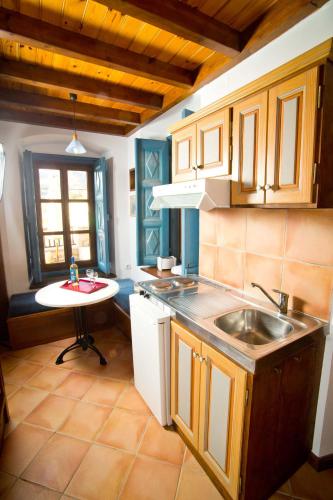 a kitchen with a sink and a counter top at Kantouni Bay Suites in Kalymnos