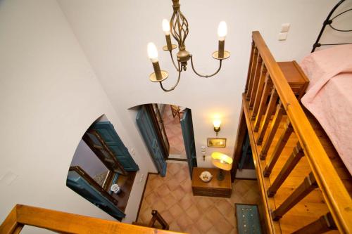 an overhead view of a staircase with a chandelier at Kantouni Bay Suites in Kalymnos