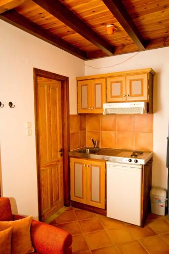 a kitchen with a sink and a stove top oven at Kantouni Bay Suites in Kalymnos