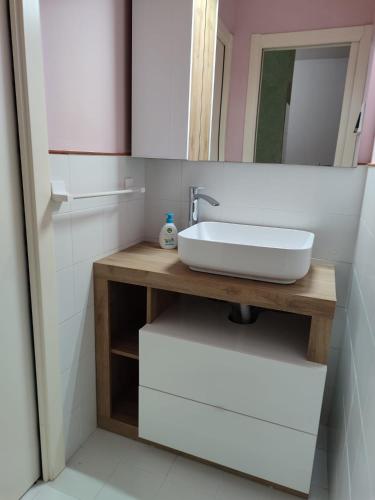 a bathroom with a sink and a mirror at Diana's home in Empoli