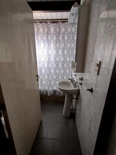 a bathroom with a sink and a mirror and a window at Casa Santa Elena in Malargüe