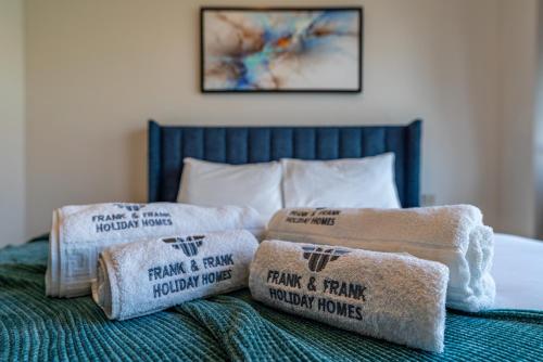 a pile of towels sitting on top of a bed at The View of a Lifetime - Luxury Living with Full Burj Khalifa & Fountain Show - 1702 in Dubai