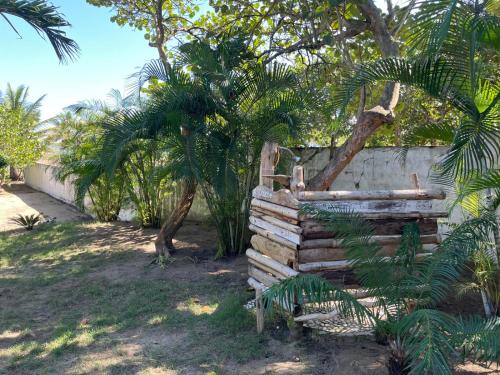 a pile of logs next to a wall with trees at Villa Bianca - BEACHFRONT with Pool in Sosúa