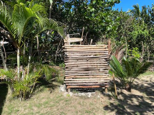 a wooden chair sitting on the grass in a garden at Villa Bianca - BEACHFRONT with Pool in Sosúa