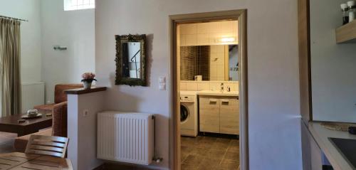 a room with a kitchen with a sink and a mirror at Villas On The Rock Afissos in Afissos