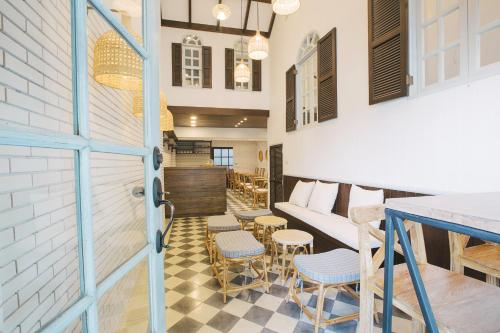 a room with a couch and chairs and a table at Amaka Bed and Breakfast in Chiang Mai