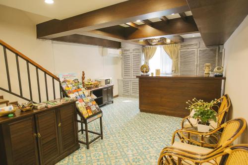 a living room with a staircase and a table and chairs at Amaka Bed and Breakfast in Chiang Mai