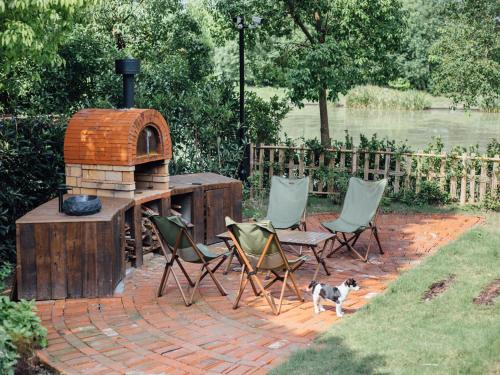 a patio with chairs and a wood fired oven at Somland Resort in Paiya