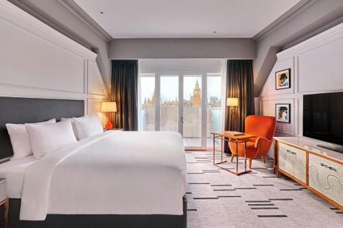 a hotel room with a large bed and a television at London Marriott Hotel County Hall in London