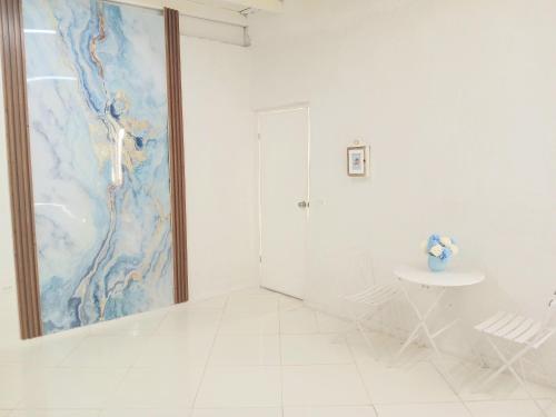a white bathroom with a shower and a table at Blue Ocean Apartment in Noord
