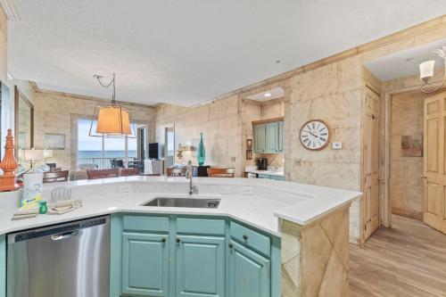 a kitchen with a sink and a clock on the wall at Spanish Key 705 in Perdido Key
