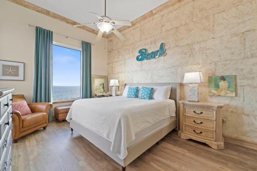 a bedroom with a bed and a window with the ocean at Spanish Key 705 in Perdido Key