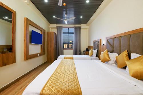 a bedroom with two beds and a flat screen tv at Hotel BKC Minerva, Near US Consulate in Mumbai