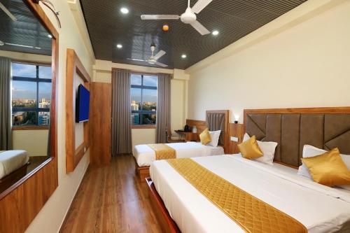 a hotel room with two beds and a window at Hotel BKC Minerva, Near US Consulate in Mumbai