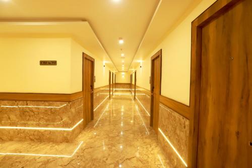a corridor of a building with a row of doors at Hotel BKC Minerva, Near US Consulate in Mumbai