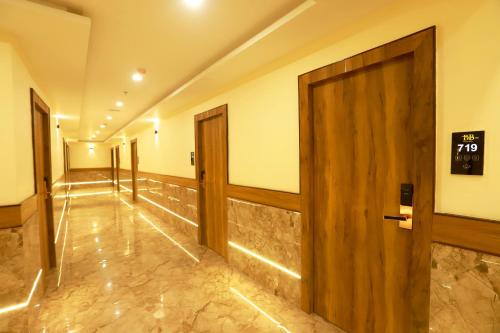 a hallway with doors and a sign on the wall at Hotel BKC Minerva, Near US Consulate in Mumbai