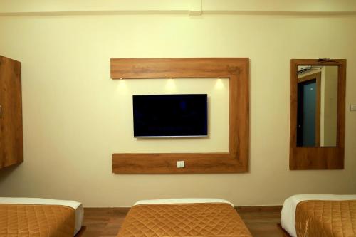 a room with a flat screen tv on a wall at Hotel BKC Minerva, Near US Consulate in Mumbai