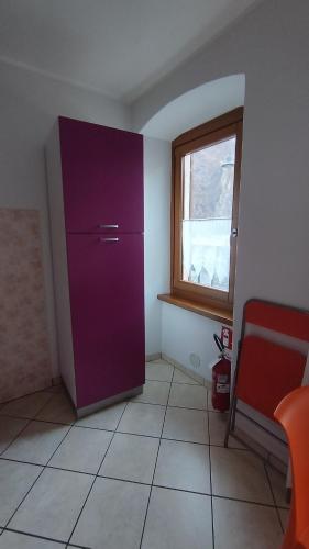 a purple refrigerator in a room with a window at Belvedere Di Simona Cotti Piccinelli in Bard