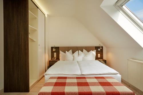 a bedroom with a bed with a checkered blanket at H+ Hotel Nürnberg in Nürnberg