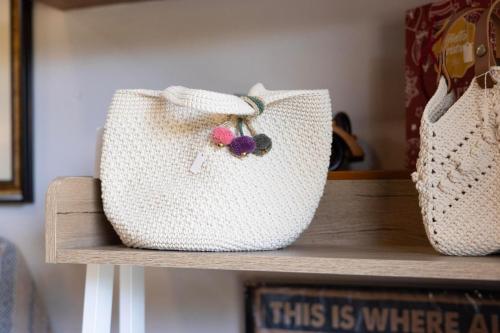 a white purse sitting on top of a shelf at Le-Mao Chiang Dao in Chiang Dao