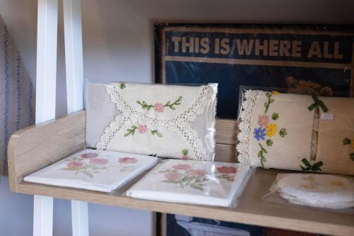 a table with three pillows on it with a shelf at Le-Mao Chiang Dao in Chiang Dao