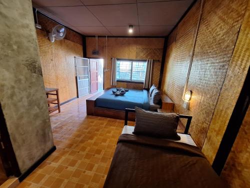a bedroom with a blue bed and a window at Slumberland at Pai in Pai