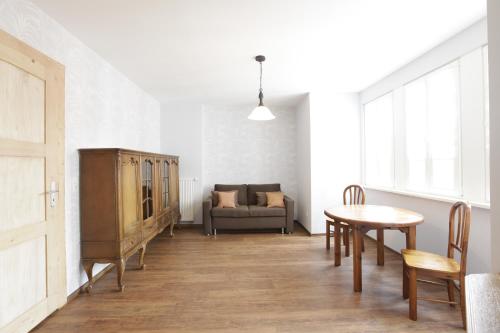 a living room with a table and a couch at Hotel am Markt Sankt Goar in Sankt Goar