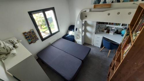 a small room with a table and a desk and a bed at Magnifique villa à 15mn des plages in Fabrègues