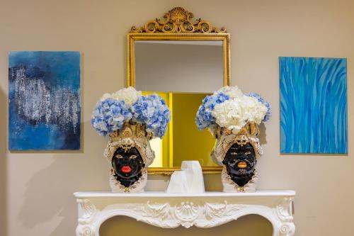 a dressing table with a mirror and a mask at Five by Capri 5 Senses in Anacapri