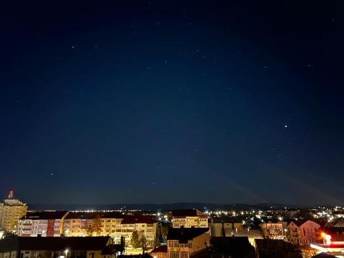 a view of a city at night at Central Residence Sky Apartment in Rădăuţi