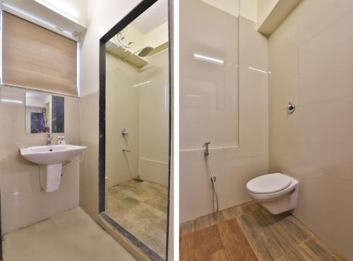 a bathroom with a toilet and a sink at Infinity Rooms D-Mart in Surat