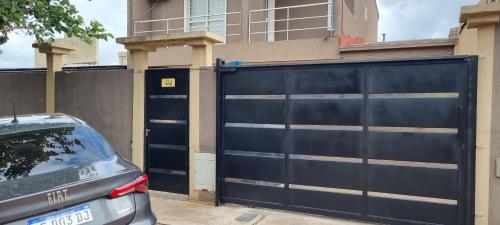 a car parked in front of a black garage at LyL in Posadas Aeroclub
