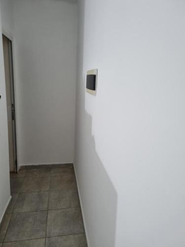 a room with a white wall and a door at LyL in Posadas Aeroclub