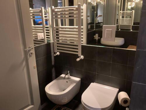 a bathroom with a white toilet and a sink at Palazzo Siena De Facendis in Bitonto