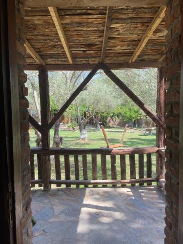 a screened porch with a view of a park at Pavelin Yeri Otel in Edremit