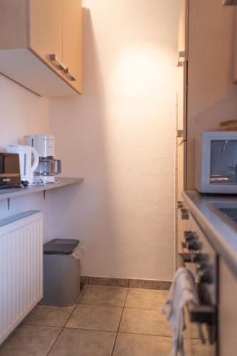 a kitchen with a sink and a microwave at FeWo Severin in Bottrop