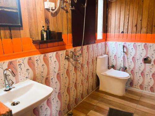 a bathroom with a sink and a toilet at Rishikesh Valley in Rishīkesh