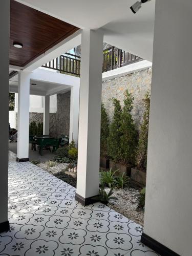 an open courtyard with a patio with a table and a patio at Dawn Boutique Luangprabang Hotel in Luang Prabang