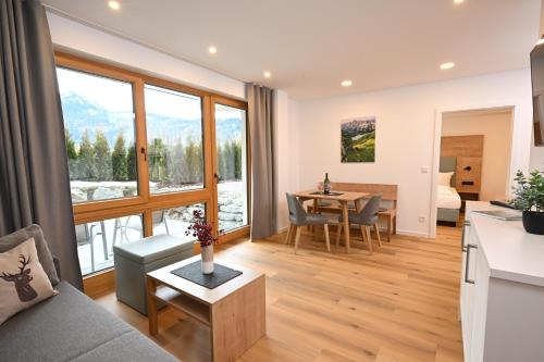 a living room with a couch and a table at Best Western Plus Hotel Alpenhof in Oberstdorf